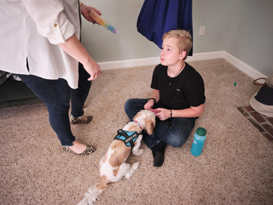 One of the family’s dogs began to alert Ayden to oncoming seizures. The dog has become Ayden’s service dog and constant companion.<span class="copyright">Julie Renée Jones for TIME</span>