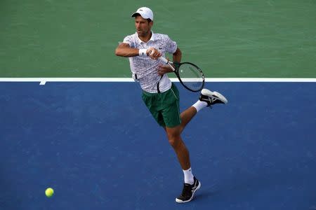 Aug 19, 2018; Mason, OH, USA; Novak Djokovic (SRB) returns a shot against Roger Federer (SUI) during the finals in the Western and Southern tennis open at Lindner Family Tennis Center. Mandatory Credit: Aaron Doster-USA TODAY Sports