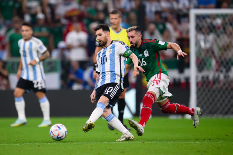 LUSAIL CITY, QATAR - NOVEMBER 26: Lionel Messi of Argentinia (L) battles for possession with Hector Herrera of Mexico (R)  during the FIFA World Cup Qatar 2022 Group C match between Argentina and Mexico at Lusail Stadium on November 26, 2022 in Lusail City, Qatar. (Photo by Markus Gilliar - GES Sportfoto/Getty Images)