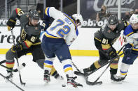 St. Louis Blues defenseman Justin Faulk (72) vies for the puck with Vegas Golden Knights defenseman Alec Martinez (23) and center Jonathan Marchessault (81) during the second period of an NHL hockey game Tuesday, Jan. 26, 2021, in Las Vegas. (AP Photo/John Locher)