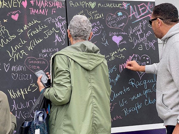 Participants at the 2021 Walk to End Alzheimer's Jacksonville write names of loved ones affected by Alzheimer's and other dementias.