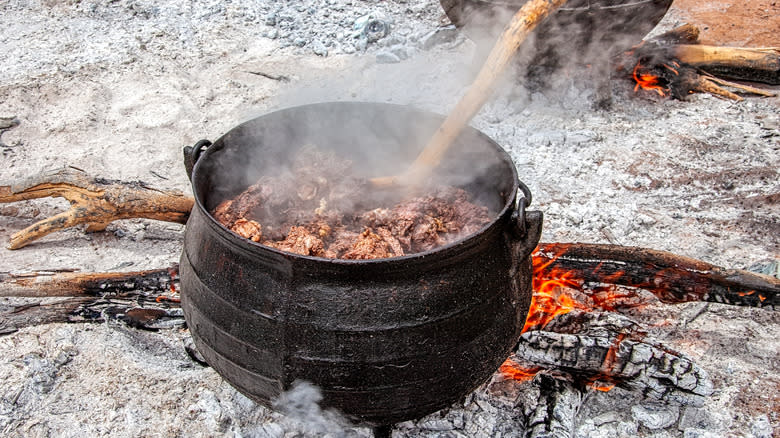 cast iron pot on campfire