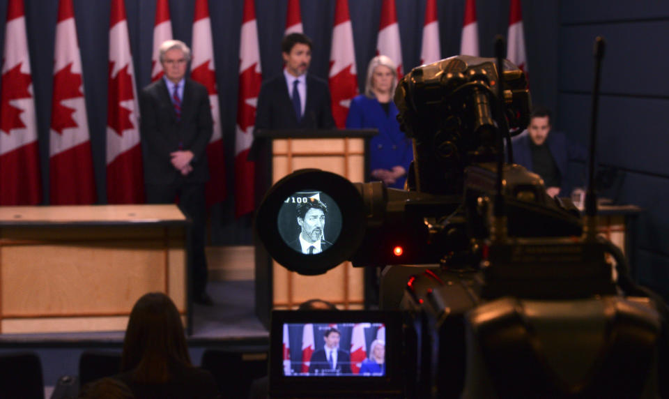 Canada Prime Minister Justin Trudeau, displayed in the viewfinder of a video camera, speaks a press conference at the National Press Theatre in Ottawa, Friday, Jan. 17, 2020. Trudeau said Friday his government will give $25,000 Canadian ($19,122 U.S.) to families of each of the 57 citizens and 29 permanent residents of Canada who perished in the downing of a Ukrainian jetliner in Iran last week. (Sean Kilpatrick/The Canadian Press via AP)