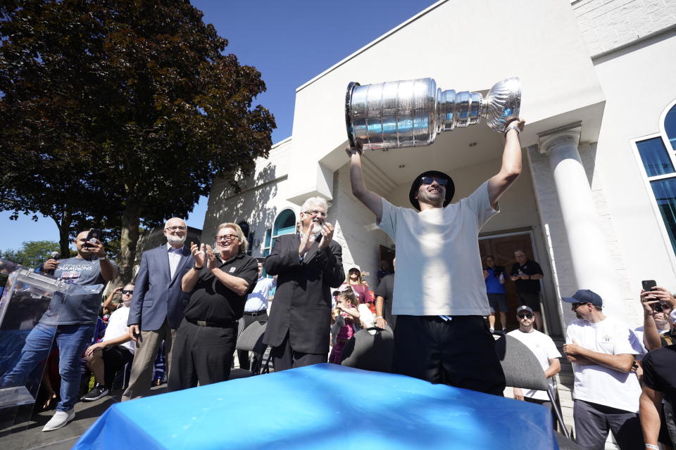 NHL player Nazem Kadri hoist the Stanley Cup in front of the London Muslim Mosque in London, Ontario on Saturday Aug. 27, 2022. Kadri, 31, won the cup for the first time while playing with the Colorado Avalanche. (Geoff Robins /The Canadian Press via AP)