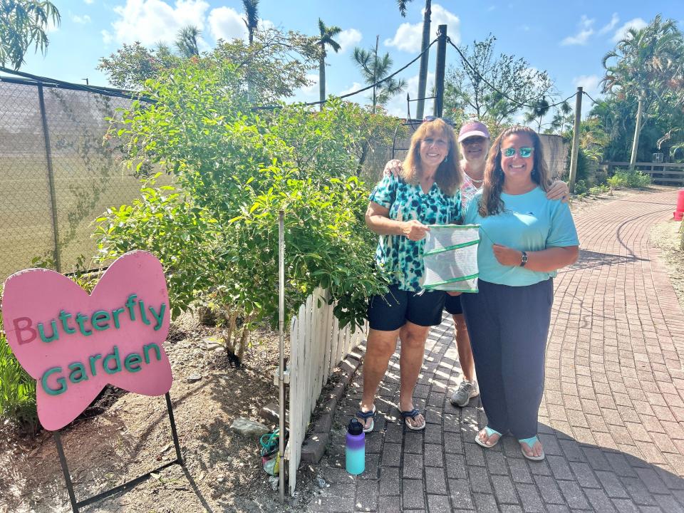 Volunteers Elizabeth Wilkerson, Tamara Gibbs and Sherri Williams (left to right) of The Florida Native Butterfly Society pose in front of their new butterfly garden at Shell Factory Nature Park.