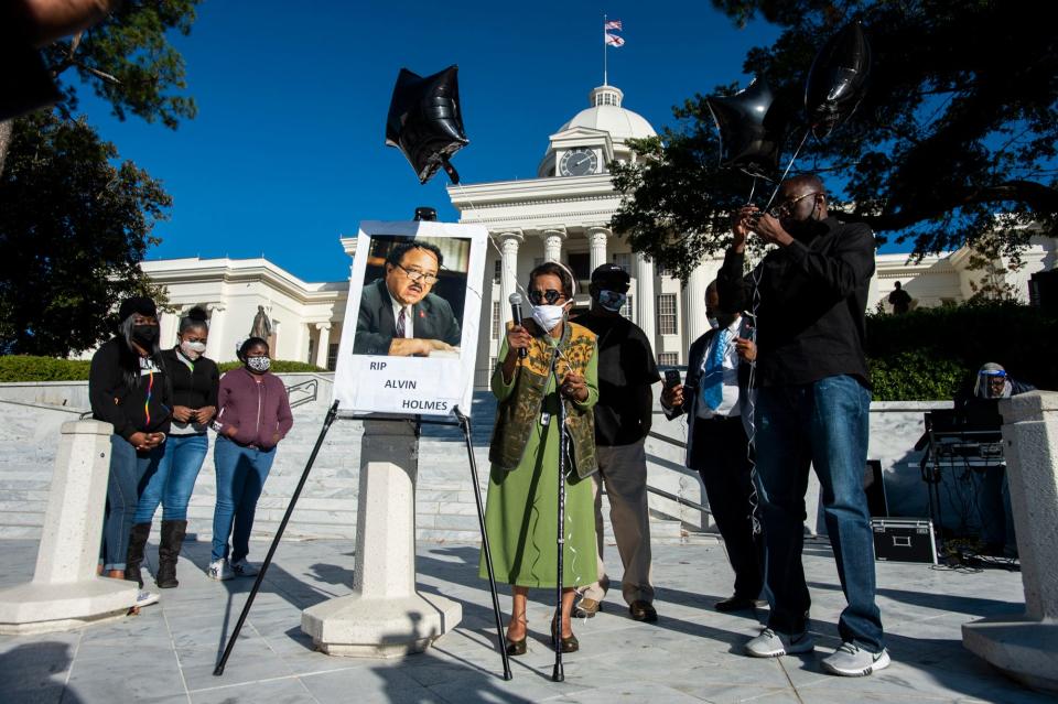 Daisy Fann releases a ballon during a ceremony to honor the late Alabama State Rep. Alvin Holmes in Montgomery, Ala., on Monday, Nov. 23, 2020.