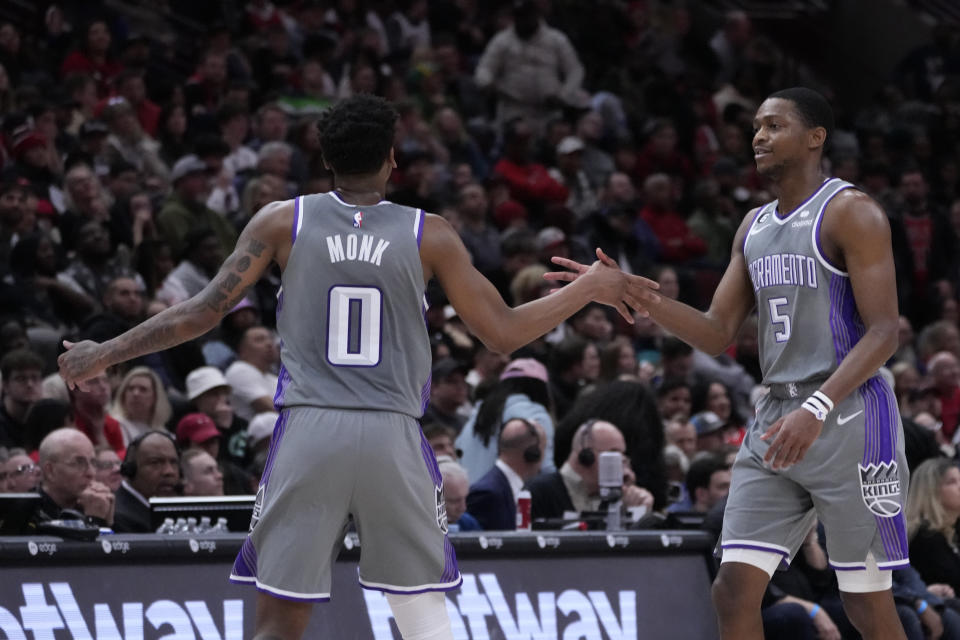 Sacramento Kings' De'Aaron Fox (5) celebrates his 3-point basket against the Chicago Bulls with Malik Monk during the second half of an NBA basketball game Wednesday, March 15, 2023, in Chicago. The Kings won 117-114. (AP Photo/Charles Rex Arbogast)