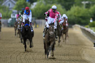 Flavien Prat atop Rombauer, center, reacts after winning the Preakness Stakes horse race at Pimlico Race Course, Saturday, May 15, 2021, in Baltimore. (AP Photo/Nick Wass)