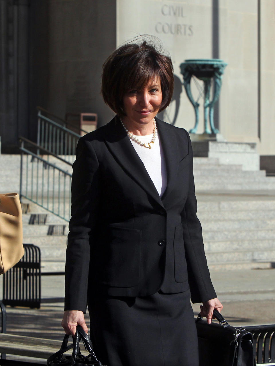 In this Wednesday, April 30, 2014 photo, Francine Katz leaves the Civil Court building in downtown St. Louis. Katz sued Anheuser-Busch in 2009, a year after resigning as vice president of communications and consumer affairs for the maker of Budweiser, Bud Light and other beers. The trail began Monday with jury selection. (AP Photo/St. Louis Post-Dispatch, Christian Gooden) EDWARDSVILLE INTELLIGENCER OUT; THE ALTON TELEGRAPH OUT