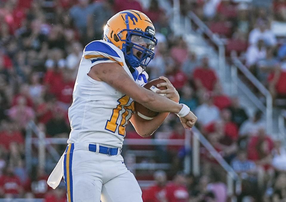 Carmel Greyhounds Jackson Kazmierczak (10) yells in excitement after a touchdown against the Center Grove Trojans on Friday, August 26, 2022 at Center Grove High School in Greenwood. The Carmel Greyhounds and Center Grove Trojans are tied at the half, 10-10. 