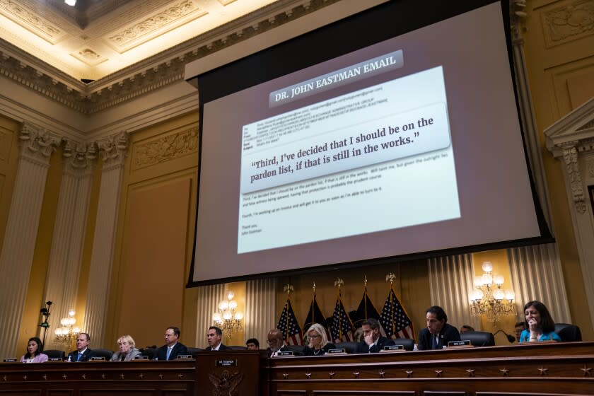 WASHINGTON, DC - JUNE 16: An excerpt from an email by Dr. John Eastman, asking for a Presidential Pardon is displayed on a screen above the dais during a House Select Committee to Investigate the January 6th hearing in the Cannon House Office Building on Thursday, June 16, 2022 in Washington, DC. The bipartisan Select Committee to Investigate the January 6th Attack On the United States Capitol has spent nearly a year conducting more than 1,000 interviews, reviewed more than 140,000 documents day of the attack. (Kent Nishimura / Los Angeles Times)