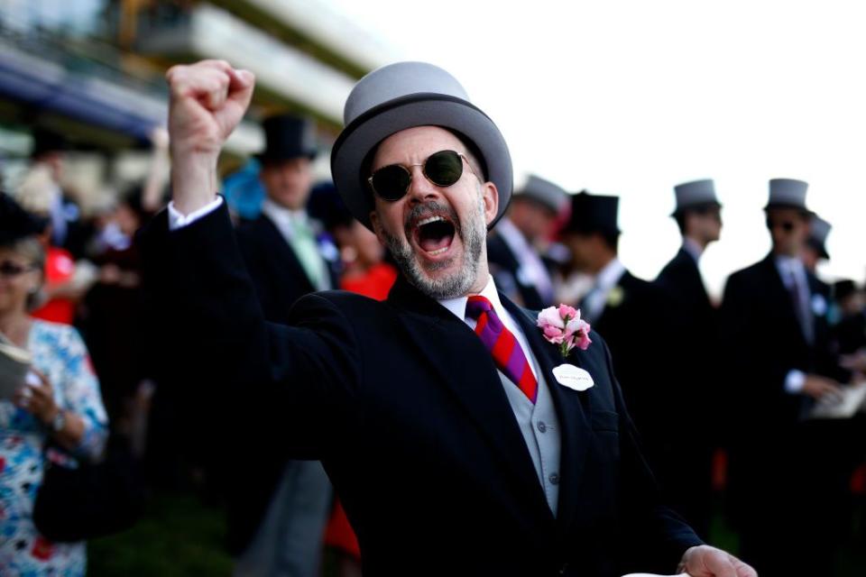 A spectator celebrates after backing the winner on Day 3.