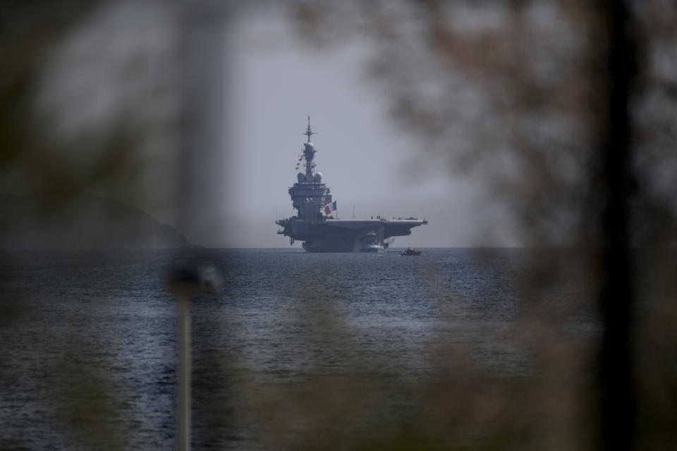 The French aircraft carrier Charles de Gaulle arrives in the bay of Toulon, southern France, Sunday April 12, 2020. The Defense Ministry said in a statement that around 40 sailors showed symptoms compatible with COVID-19, the disease the coronavirus causes. The new coronavirus causes mild or moderate symptoms for most people, but for some, especially older adults and people with existing health problems, it can cause more severe illness or death. (AP Photo/Daniel Cole)