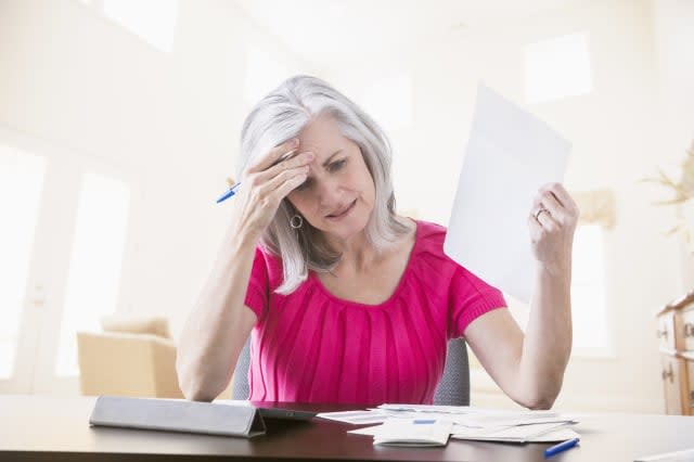 Frustrated woman paying bills online