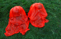 <p>Pilgrims wearing raincoats pray before the opening ceremony of World Youth Day in Krakow, Poland, July 26, 2016. (REUTERS/David W Cerny)</p>