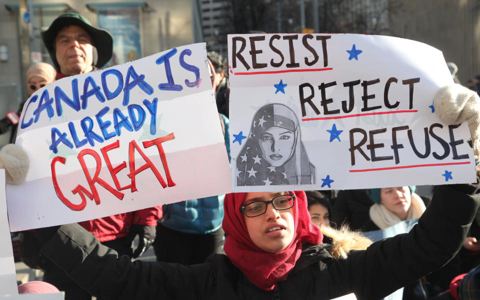 A Muslim woman holding a sign during a massive protest against President Trump's travel ban outside of the U.S. Consulate in downtown Toronto, Ontario, Canada, on Jan. 30, 2017.