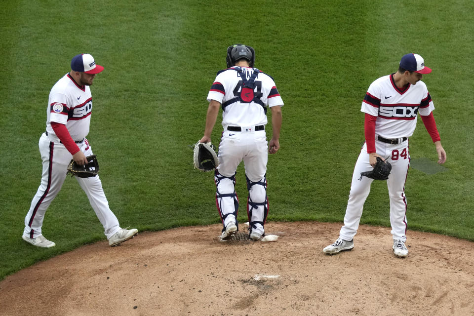 Chicago White Sox third baseman Jake Burger, left, catcher Seby Zavala, center, and starting pitcher Dylan Cease wait for pitching coach Ethan Katz during the fourth inning of a baseball game against the Baltimore Orioles in Chicago, Sunday, April 16, 2023. (AP Photo/Nam Y. Huh)