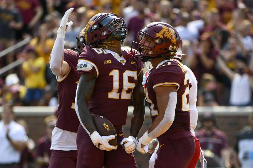 Minnesota wide receiver Dylan Wright, left, celebrates with running back Bryce Williams after Wright scored a touchdown on a 25 yard pass against Miami-Ohio during the first half of an NCAA college football game on Saturday, Sept. 11, 2021, in Minneapolis. (AP Photo/Craig Lassig)