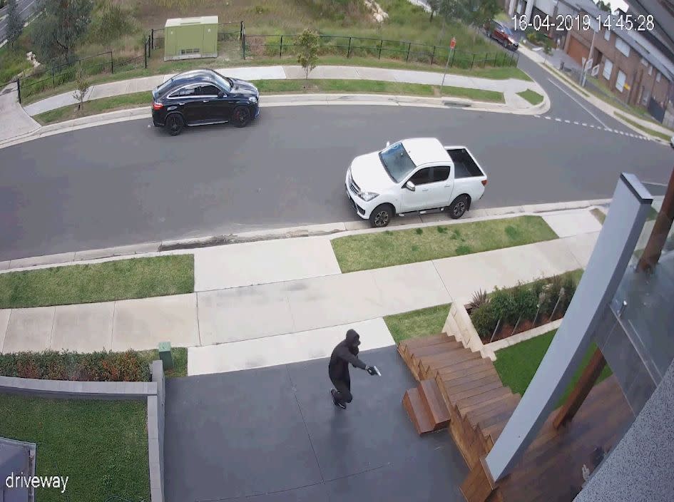 A gunman is seen on the footage opening fire at a man in Caddens. Source: NSW Police