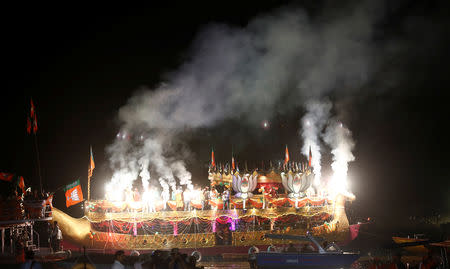 India's Prime Minister Narendra Modi's supporters light fireworks as they stand at a boat on the banks of the river Ganges, after Modi's roadshow in Varanasi, India, April 25, 2019. REUTERS/Adnan Abidi