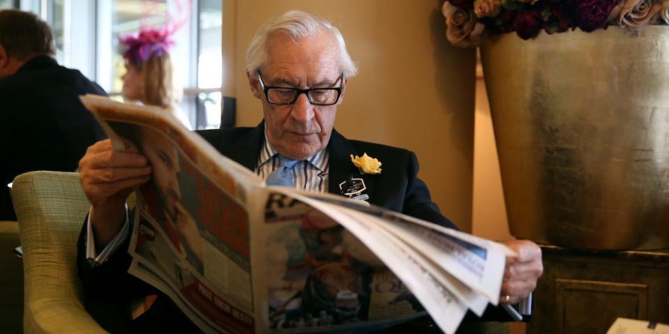wealthy retiree reading newspaper