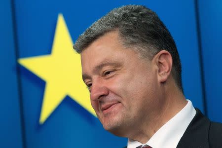 Ukraine's President Petro Poroshenko smiles as he speaks during a news conference at the EU Council in Brussels June 27, 2014. REUTERS/Philippe Wojazer