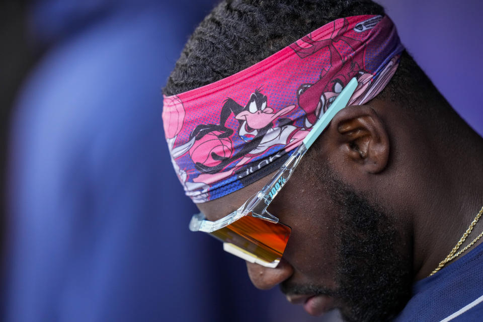 Atlanta Braves center fielder Michael Harris II looks at tablet in the dugout during the fourth inning of the team's baseball game against the Washington Nationals at Nationals Park, Saturday, April 1, 2023, in Washington. (AP Photo/Alex Brandon)