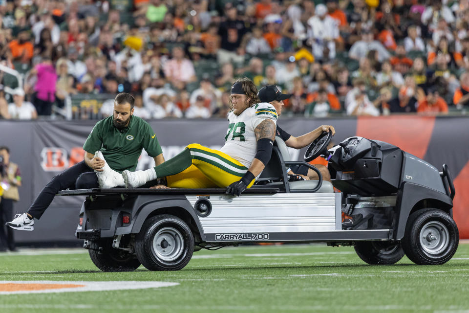 CINCINNATI, OHIO – AUGUST 11: Offensive tackle Luke Tenuta #78 of the Green Bay Packers is carted off the field against the <a class="link " href="https://sports.yahoo.com/nfl/teams/cincinnati/" data-i13n="sec:content-canvas;subsec:anchor_text;elm:context_link" data-ylk="slk:Cincinnati Bengals;sec:content-canvas;subsec:anchor_text;elm:context_link;itc:0">Cincinnati Bengals</a> during a preseason game at Paycor Stadium on August 11, 2023 in Cincinnati, Ohio. (Photo by Michael Hickey/Getty Images)