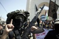 An Islamic Jihad fighter poses during a rally in support of Mohammed Allan