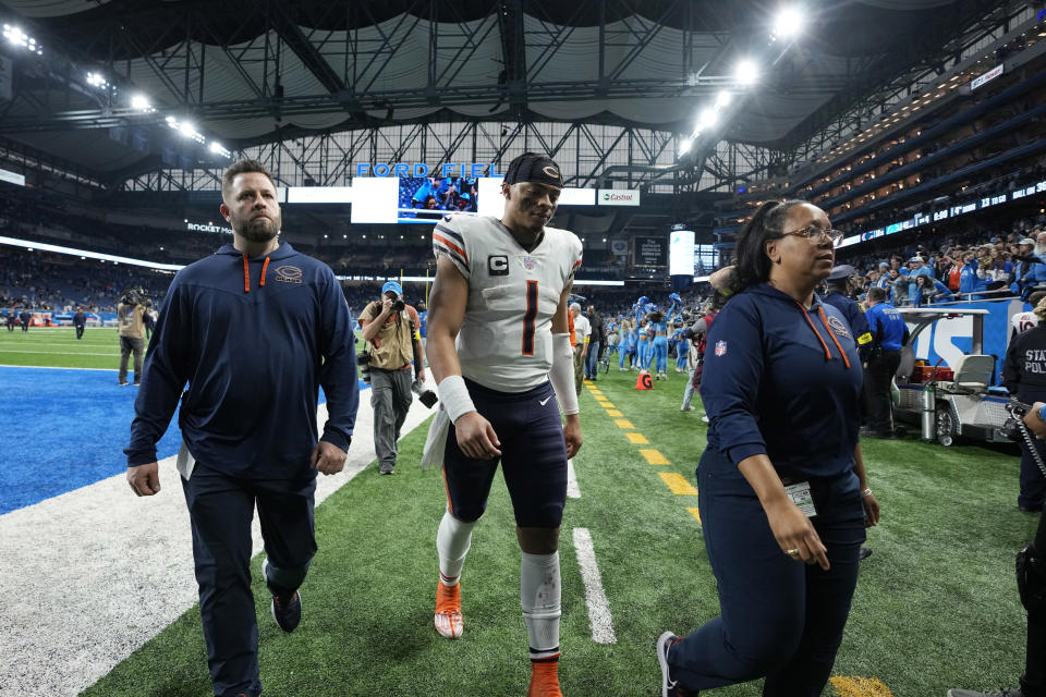 Chicago Bears quarterback Justin Fields walks off the field after an NFL football game against the Detroit Lions, Sunday, Jan. 1, 2023, in Detroit. (AP Photo/Paul Sancya)