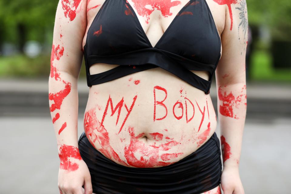 Rory Phillips wears body paint in defense of abortion rights during the Defend Roe rally on Sunday at the Oregon State Capitol in Salem.