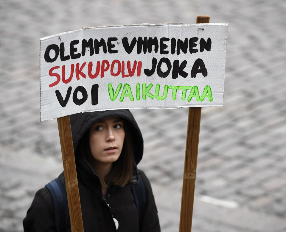 A young demonstrator holds a placard reading 'We are the last generation that can effect', prior to the start of a protest march of Finnish youth calling for climate protection, in Helsinki, Finland, Friday, March 15, 2019. (Heikki Saukkomaa/Lehtikuva via AP)