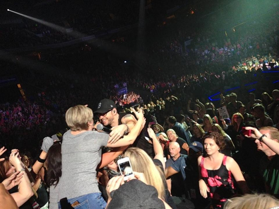 In this 2013 Observer file photo, Donnie Wahlberg hugs a fan during a New Kids on the Block concert at the arena.