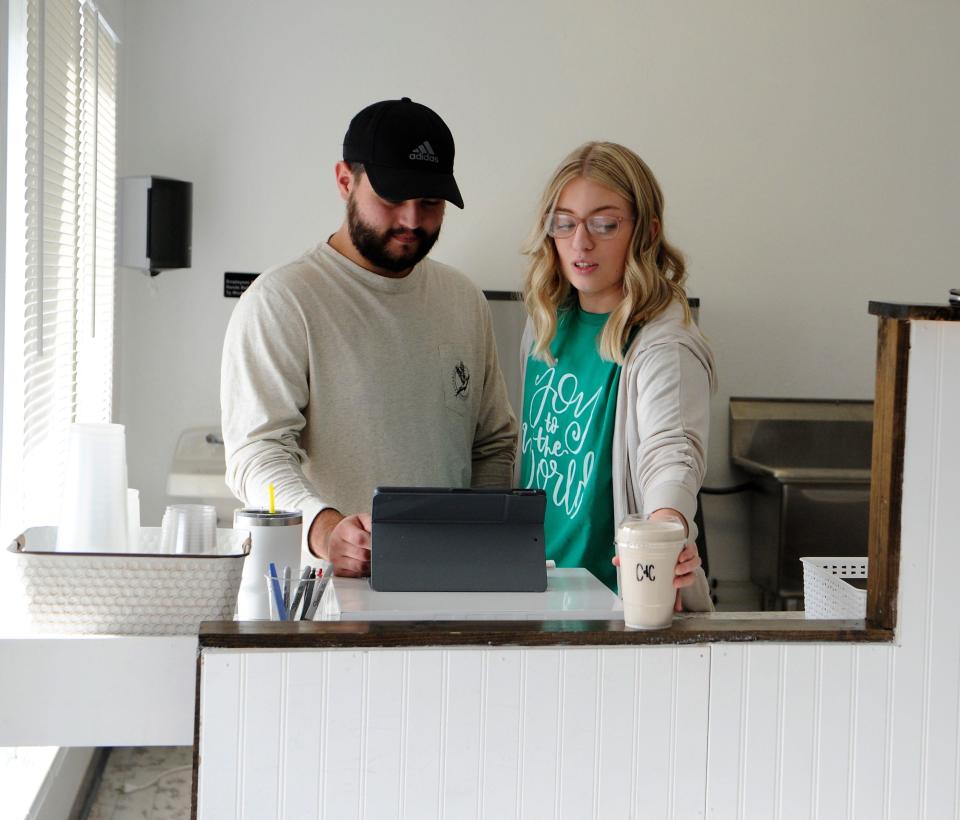 Devin, left, and Alex Bullard serve a cookies and cream protein shake at Corner Nutrition on Saturday, Nov. 27, 2021.