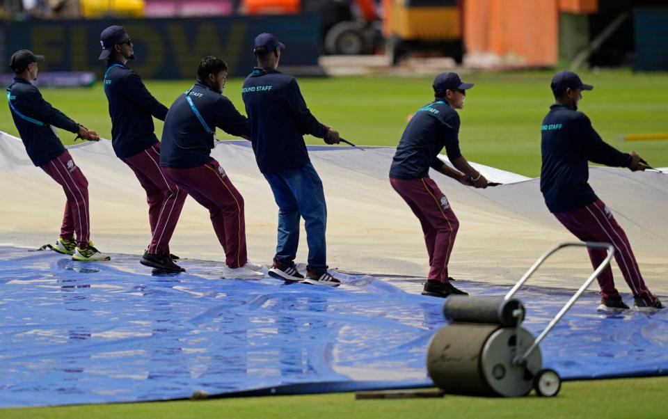 The groundstaff pulling the covers off