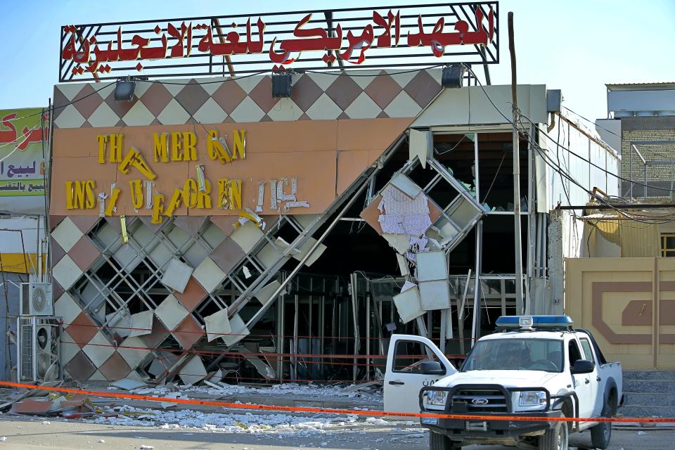 Security forces stand guard after an attack near the American Institute for English Learning in Najaf, Iraq, Friday, Sept. 18, 2020. An IED attack on the American Institute for English Learning in southern Iraq caused major damage without casualties in the early hours on Friday. according to Iraq security officials. (AP Photo/Anmar Khalil)