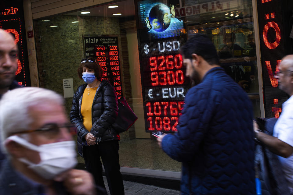 People walk past a money exchange shop in Istanbul, Turkey, Thursday, Oct. 21, 2021. Many Turkish consumers are faced with increased hardship as prices of food and other goods have soared in recent years. The yearly consumer price index increased by 19.9% in October, up from 19.58% in September, according to official data by the Turkish Statistical Institute released on Nov. 3. (AP Photo/Francisco Seco)