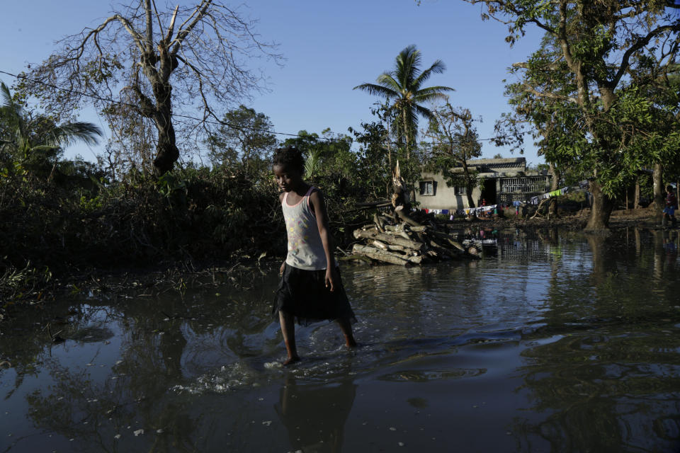 A young girl walks in the water at Mafambisse, about 60km outside of Beira, Mozambique, Tuesday, March 26, 2019. Cyclone-ravaged Mozambique faces a "second disaster" from cholera and other diseases, the World Health Organisation warned on Tuesday, while relief operations pressed into rural areas where an unknown number of people remain without aid more than 10 days after the storm. (AP Photo/Themba Hadebe)