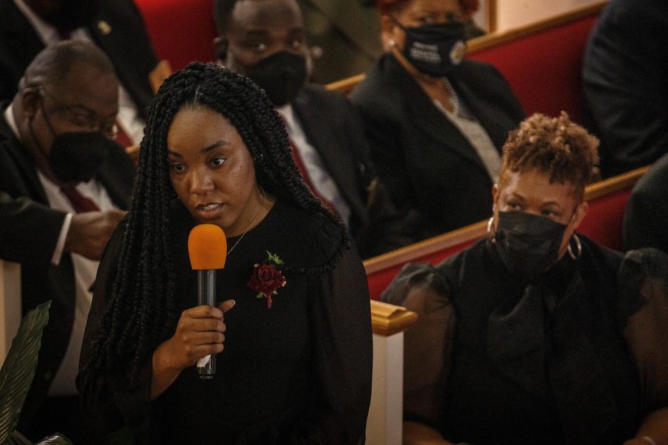 Maiah Andrews, Floyd Andrews' granddaughter, reads from the New Testament during funeral services at Payne Chapel AME Church.