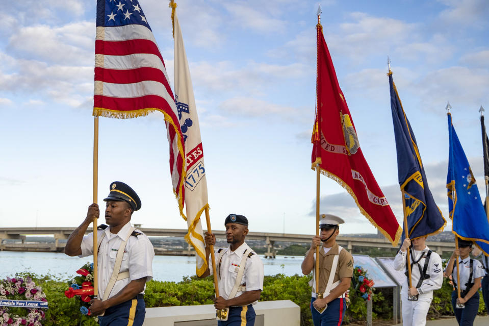 The Joint Service Color Guard presents the colors as part of the 82nd Pearl Harbor Remembrance Day ceremony on Thursday, Dec. 7, 2023, at Pearl Harbor in Honolulu, Hawaii. (AP Photo/Mengshin Lin)