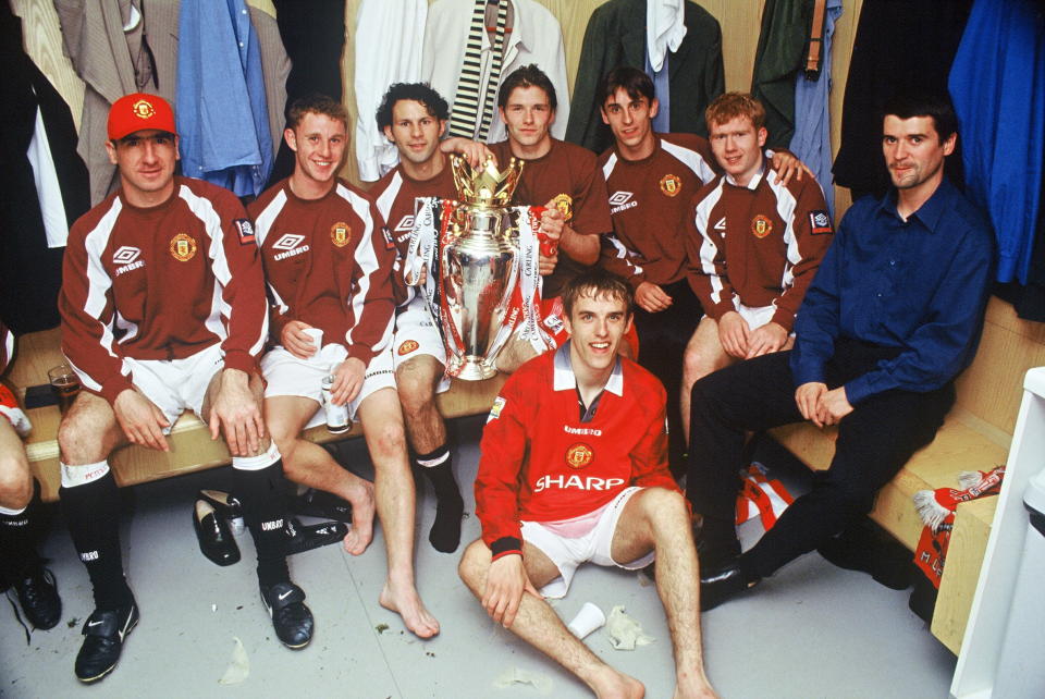 MANCHESTER, ENGLAND - MAY 11:  Eric Cantona, Nicky Butt, Ryan Giggs, David Beckham, Gary Neville, Paul Scholes, Roy Keane and Phil Neville of Manchester United celebrate in the dressing room with the FA Carling Premiership trophy after the match between West Ham United v Manchester United at Upton Park on May 11, 1997 in London. Manchester United 2 West Ham United 0.  (Photo by John Peters/Manchester United via Getty Images)