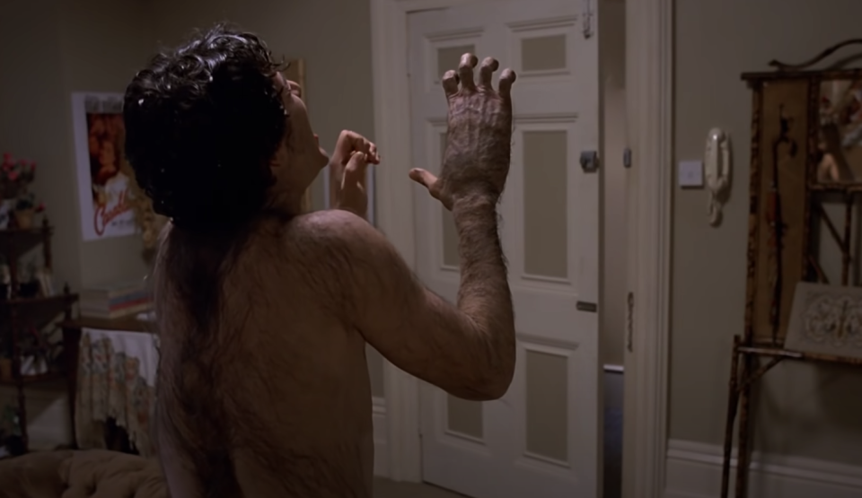 man in a bedroom transforming into a werewolf