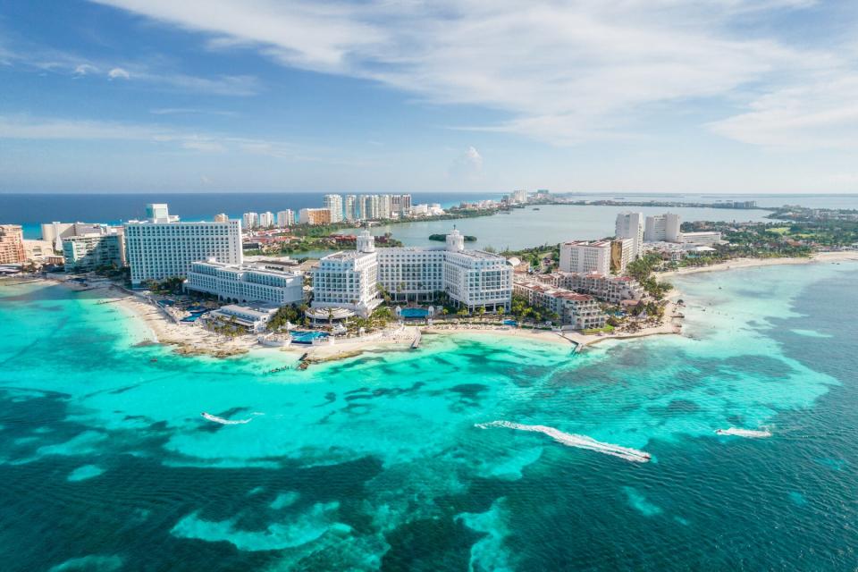 Aerial panoramic view of Cancun beach and city hotel zone in Mexico. Caribbean coast landscape of Mexican resort with beach Playa Caracol and Kukulcan road. Riviera Maya in Quintana roo region on Yucatan Peninsula