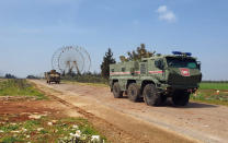 FILE - In this photo provided by the Turkish Defense Ministry, Turkish and Russian troops patrol on the M4 highway, which runs east-west through Idlib province, Syria, March 15, 2020. Political observers say Russia’s brazen Syria intervention emboldened Putin, giving him a renewed Middle East foothold and helped pave the way for his current attack on Ukraine. (Turkish Defense Ministry via AP, File)