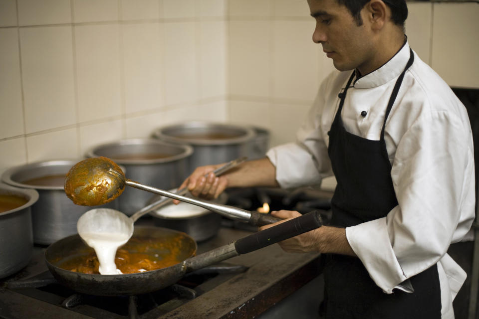 A chef prepares butter chicken at Moti Mahal restaurant in Old Delhi, India. / Credit: In Pictures Ltd./Corbis via Getty