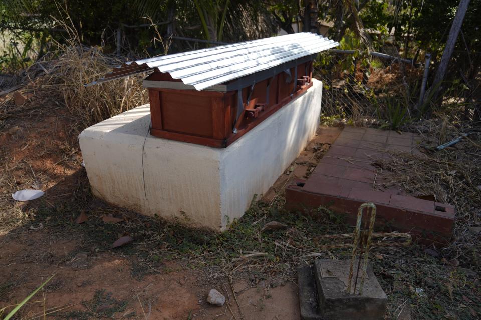 The coffin of miner Santiago Mora sits ready for burial at the cemetery in La Paragua, Bolivar state, Venezuela, Thursday, Feb. 22, 2024. The collapse of an illegally operated open-pit gold mine in central Venezuela killed at least 14 people and injured several more, state authorities said Wednesday, as some other officials reported an undetermined number of people could be trapped. (AP Photo/Ariana Cubillos)