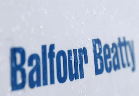 Raindrops are seen on a sign at a Balfour Beatty construction site in central London