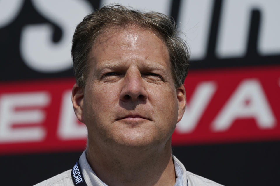 New Hampshire Governor Chris Sununu stands during driver introductions prior to an auto race at the New Hampshire Motor Speedway, Sunday, July 17, 2022, in Loudon, N.H. As a former ski resort executive, Sununu knows something about navigating slippery slopes. But recent controversy at a county-owned ski area has raised questions about his grip on the Republican Party heading into the November elections. (AP Photo/Charles Krupa)