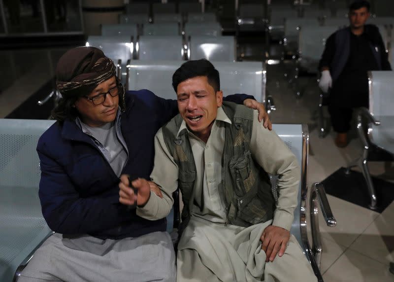 Man who lost his brother mourns at a hospital after a suicide bombing in Kabul