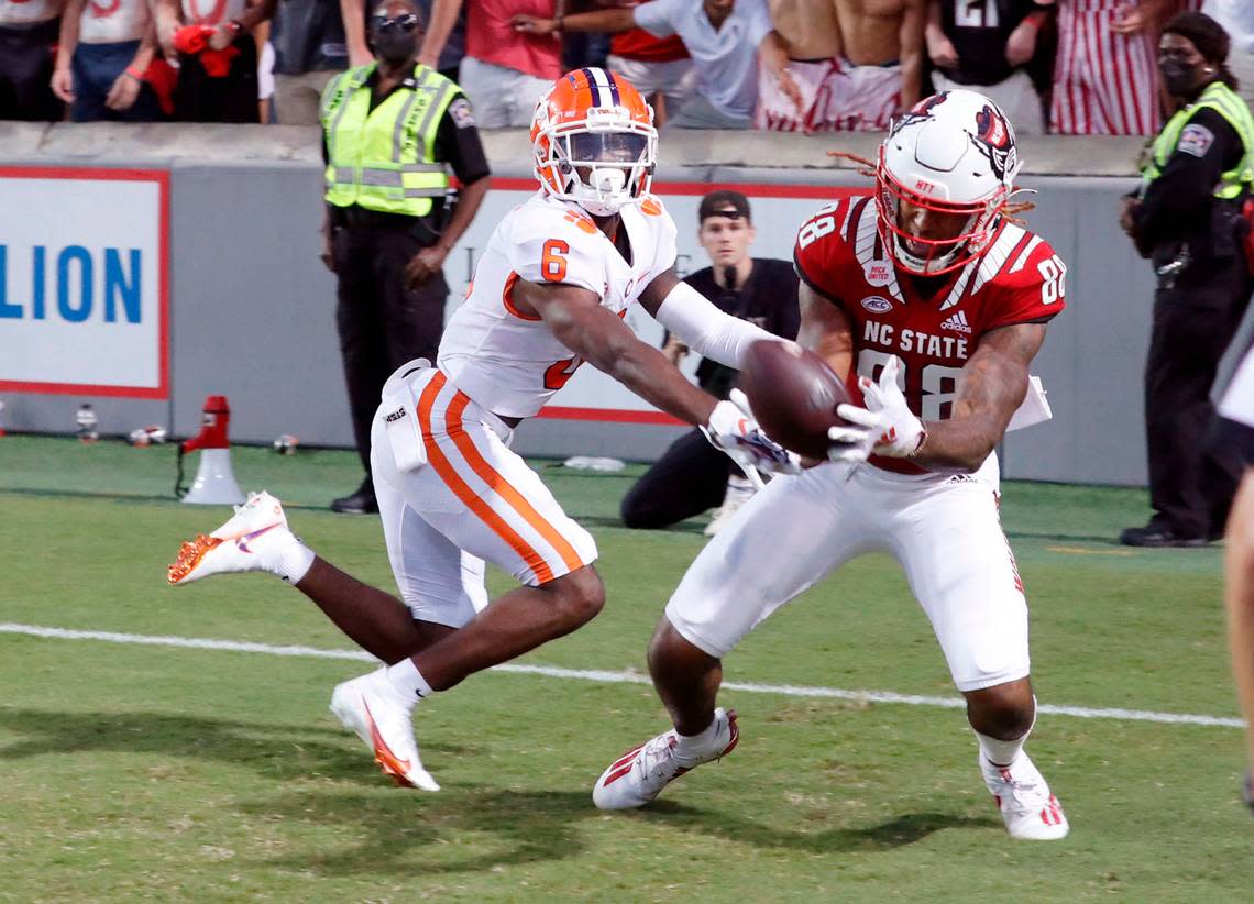 N.C. State wide receiver Devin Carter (88) makes the 22-yard touchdown reception in the second overtime as Clemson cornerback Sheridan Jones (6) defends during N.C. State’s 27-21 overtime victory over Clemson at Carter-Finley Stadium in Raleigh, N.C., Saturday, Sept. 25, 2021.